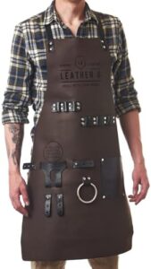 Master your grilling skills with the Leather G apron featuring storage pockets, adjustable straps and a beer holder. Perfect for BBQ enthusiasts, this durable apron ensures protection and style while cooking outdoors.