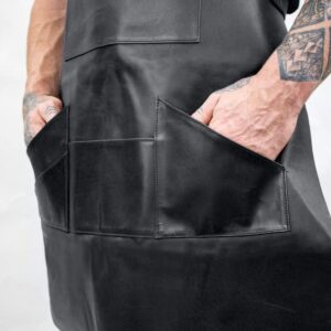 Elevate your workwear style with the Lindsey Street Black Leather Apron, featuring spacious pockets and a durable leather design. Perfect for baristas, bakers, and chefs alike!