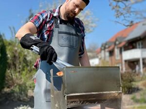 Protect your clothes and grill with the Fennek Barbeque Apron, made from durable leather for a stylish and practical cooking companion, perfect for any backyard barbecue or outdoor party.