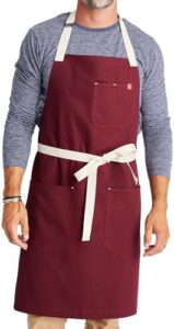 "Protect your chef's uniform with the Hedley & Bennett Essential Apron, featuring pockets and an adjustable bib strap for cooking and grilling. Perfect for professional chefs."