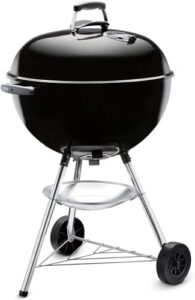 Compact and portable charcoal BBQ for small spaces, featuring a black design and grill cover. Perfect for camping trips or backyards!